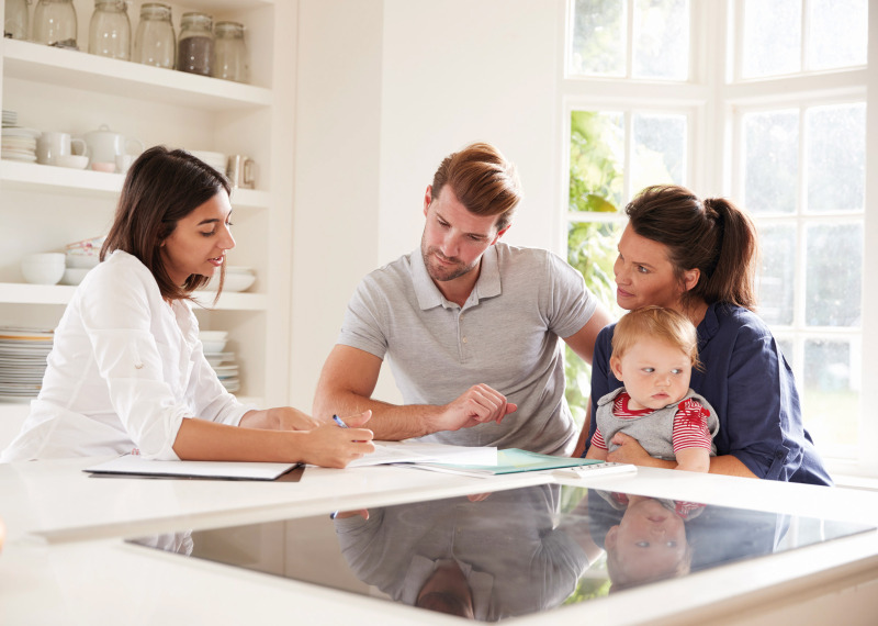 Family in kitchen with adviser original